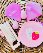 Unboxed beauty tools: puffs, blender sponges, comb and plush pouch