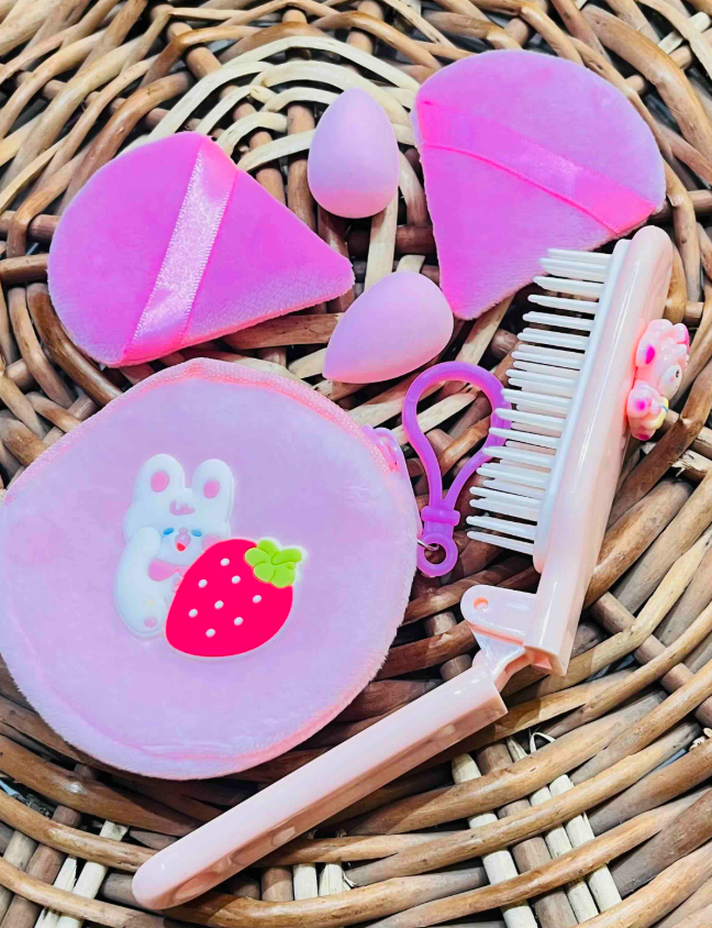 Close-up of foldable comb, plush pouch, puffs and blender sponges
