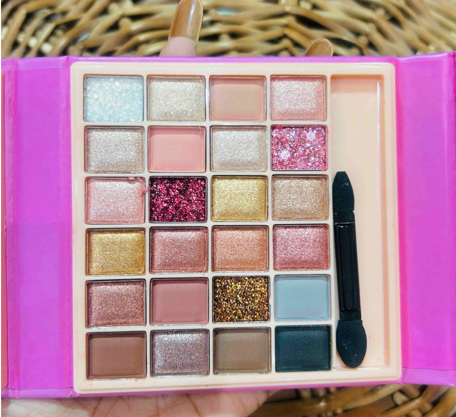 Close up of 24-shade eyeshadow grid with applicator