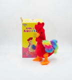 Electric plush rooster toy with rainbow tail beside its box