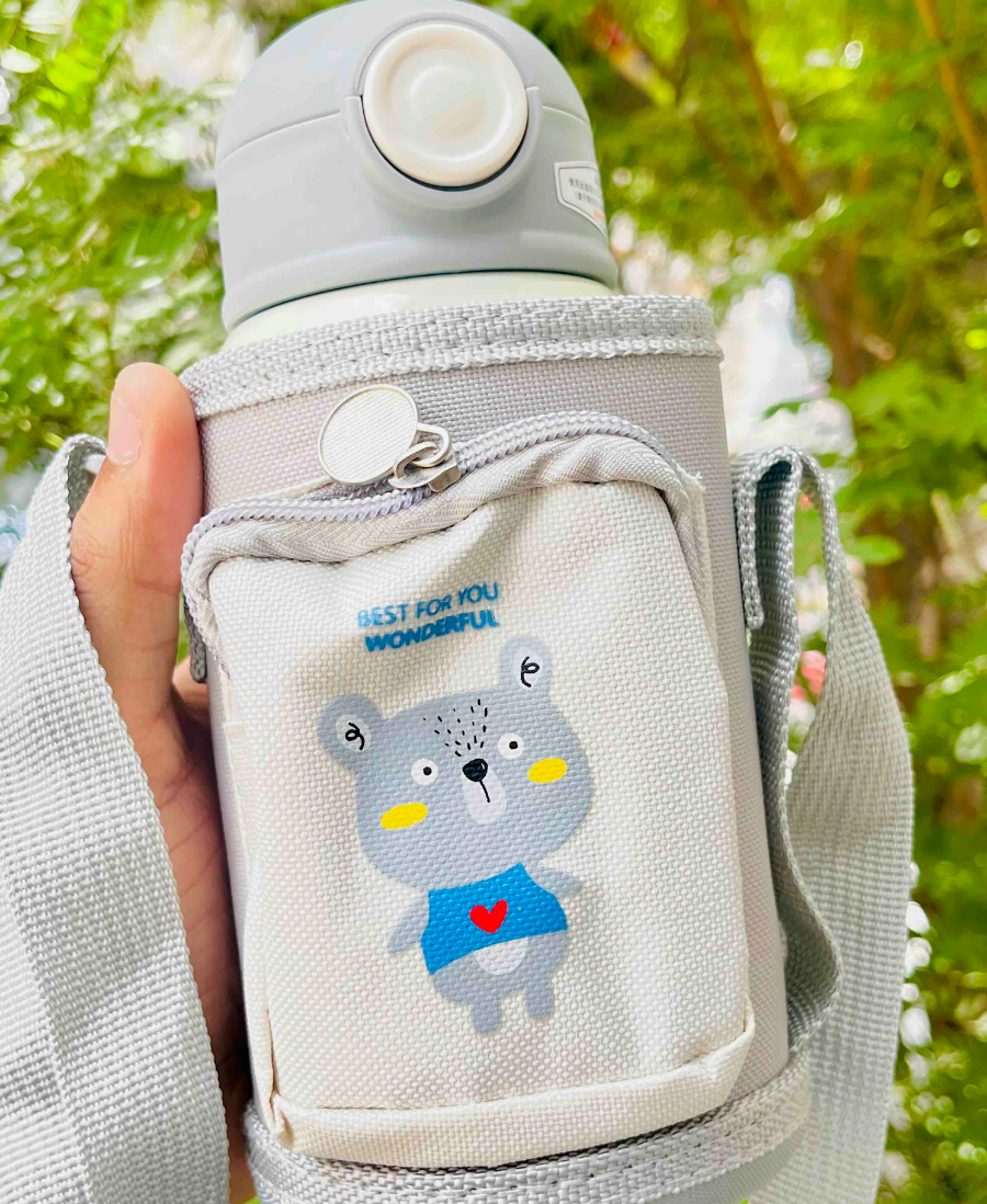 Grey carry pouch with bear print and adjustable strap on bottle